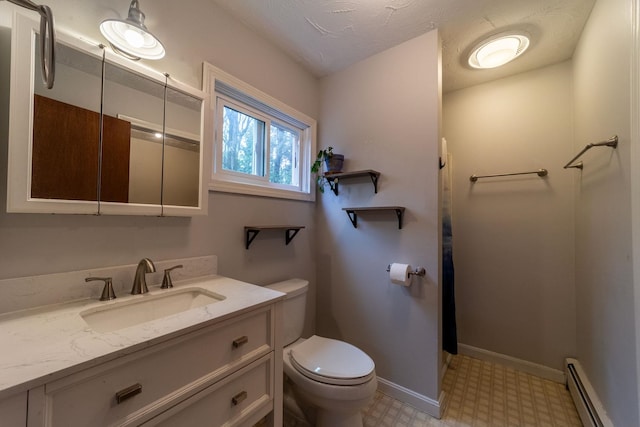 bathroom with a baseboard heating unit, toilet, tile patterned floors, vanity, and baseboards