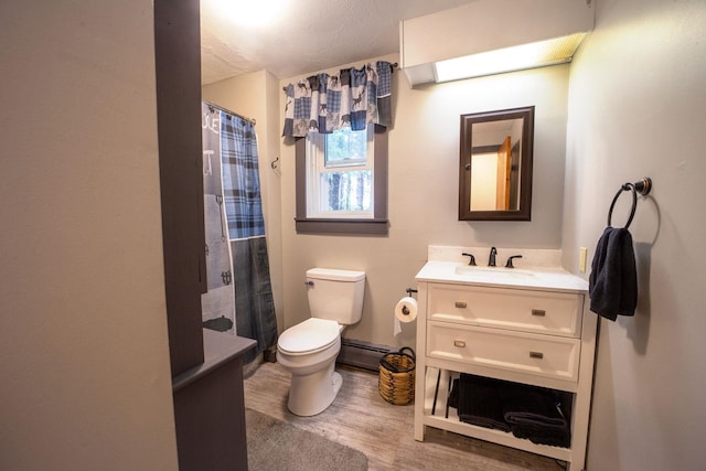 bathroom featuring baseboard heating, toilet, wood finished floors, vanity, and a shower with curtain