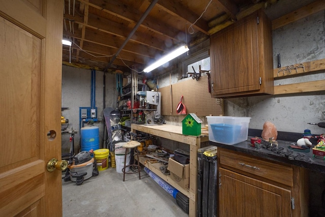 unfinished basement featuring a workshop area