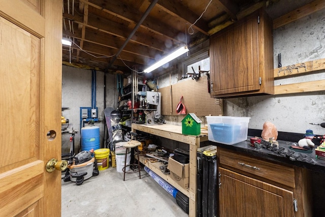 unfinished basement featuring a workshop area