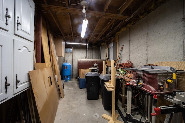 unfinished below grade area with a water pressure tank