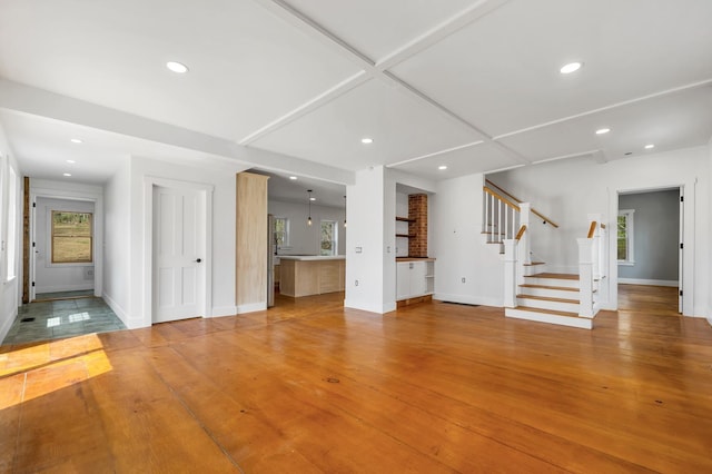 unfurnished living room with stairway, recessed lighting, baseboards, and light wood finished floors