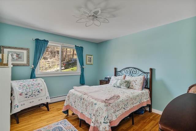 13 Ewing St, Montpelier, VT 05602 - bedroom with a baseboard radiator, wood finished floors, and baseboards