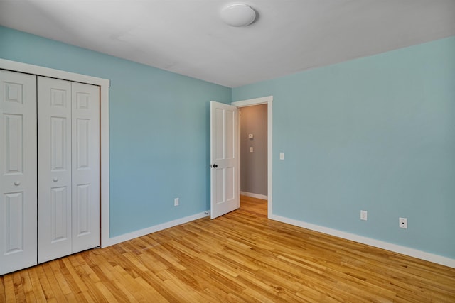 13 Ewing St, Montpelier, VT 05602 - unfurnished bedroom featuring baseboards, light wood finished floors, and a closet