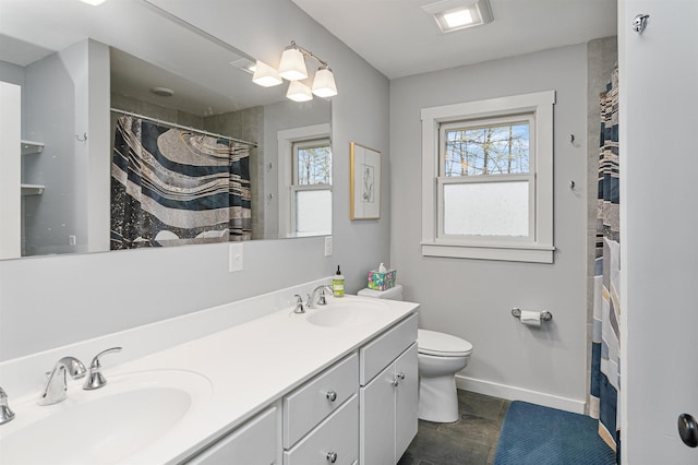 13 Ewing St, Montpelier, VT 05602 - full bath with toilet, baseboards, double vanity, and a shower with curtain