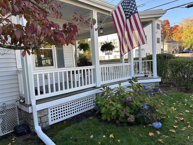 view of side of property featuring covered porch