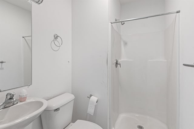 193 St Paul St Unit 101, Burlington, VT 05401 - bathroom featuring a sink, a shower stall, and toilet