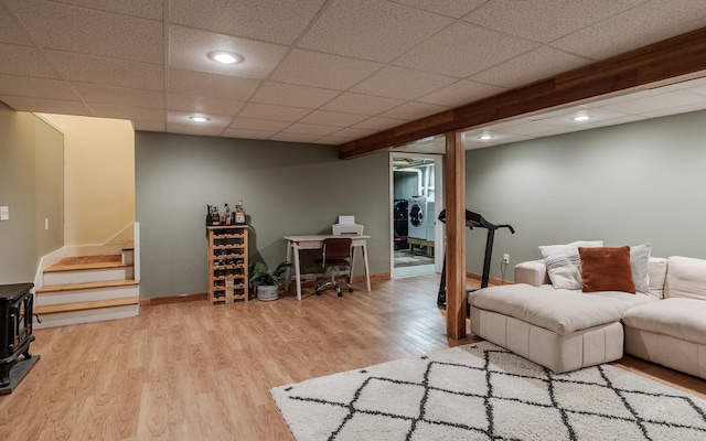 living room featuring washer and clothes dryer, wood finished floors, stairs, recessed lighting, and baseboards