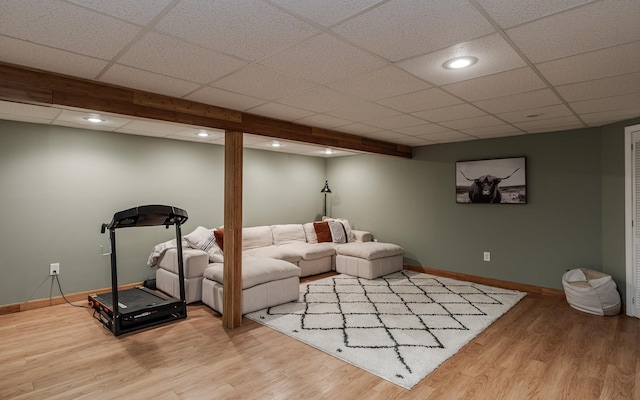 living area featuring baseboards, wood finished floors, a paneled ceiling, and recessed lighting