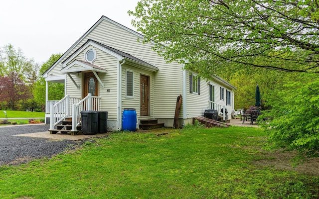 rear view of property with a yard and a patio area
