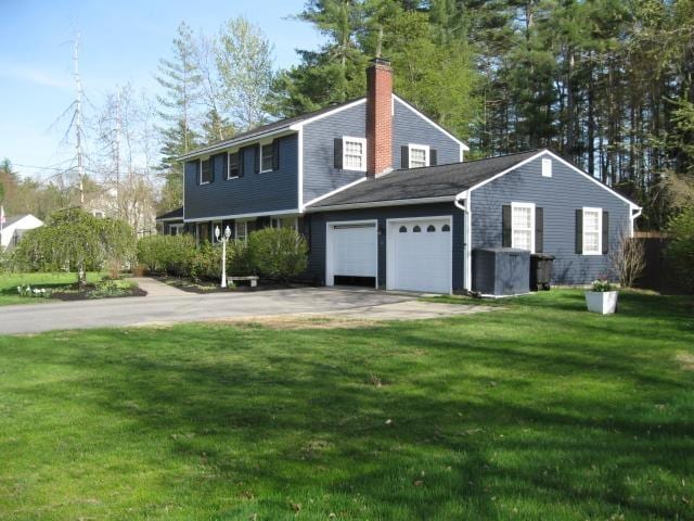 25 Centerview Dr, Swanzey, NH 03446 - view of front of home with an attached garage, a front yard, a chimney, and driveway