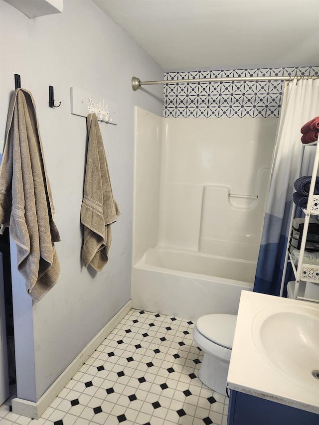 bathroom with vanity, baseboards, toilet, shower / tub combo with curtain, and tile patterned floors