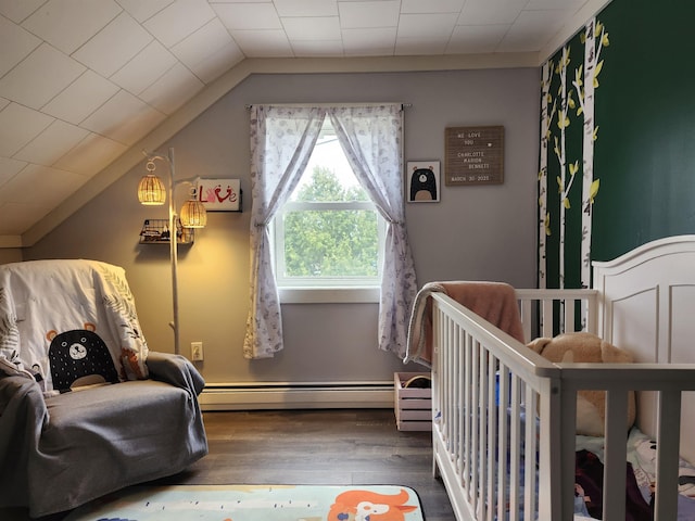 bedroom with baseboard heating, wood finished floors, and vaulted ceiling