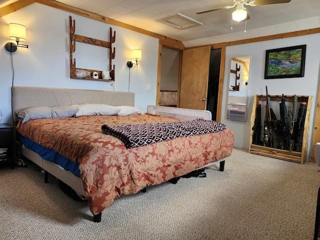 carpeted bedroom featuring attic access and a ceiling fan