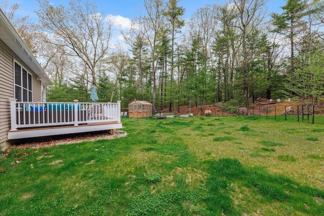 11 Carriage Hill Rd, Wilton, NH 03086 - view of grassy yard featuring a deck, an outbuilding, and an exterior structure