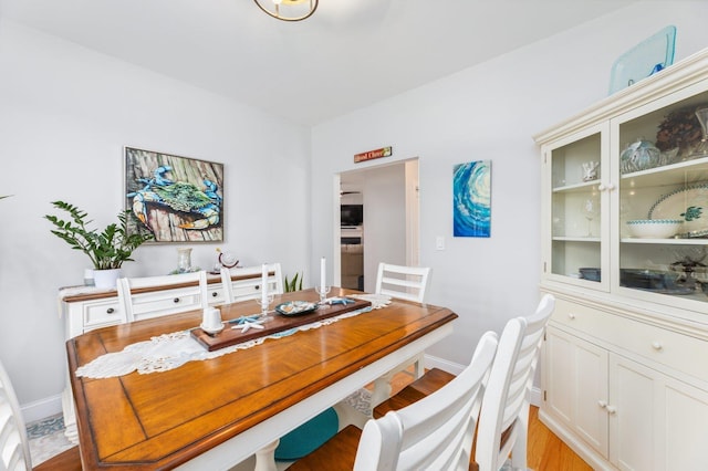 11 Carriage Hill Rd, Wilton, NH 03086 - dining space with baseboards and light wood-style floors
