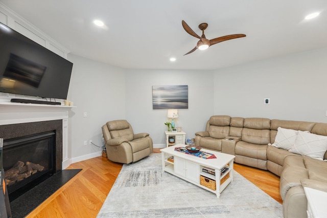 11 Carriage Hill Rd, Wilton, NH 03086 - living area with ceiling fan, light wood finished floors, recessed lighting, a glass covered fireplace, and baseboards