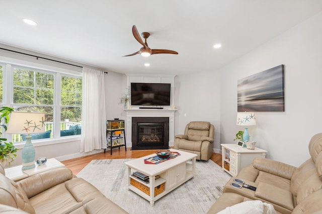11 Carriage Hill Rd, Wilton, NH 03086 - living area with ceiling fan, light wood-type flooring, a glass covered fireplace, recessed lighting, and baseboards