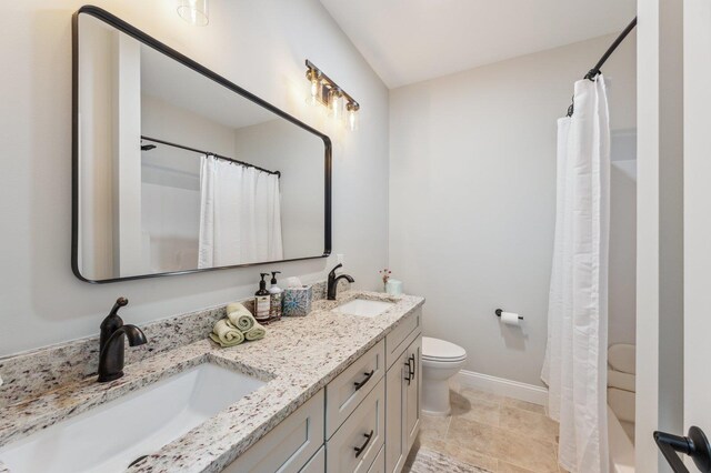 11 Carriage Hill Rd, Wilton, NH 03086 - bathroom featuring toilet, baseboards, double vanity, and a shower with curtain