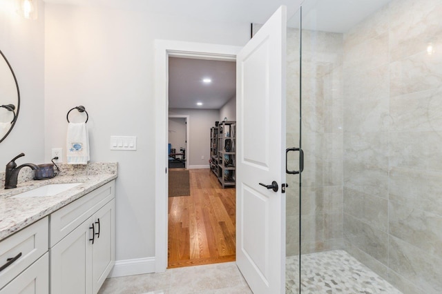 11 Carriage Hill Rd, Wilton, NH 03086 - bathroom featuring a shower stall, baseboards, vanity, wood finished floors, and recessed lighting