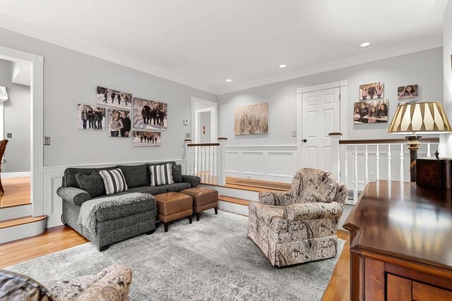 12 Mcintosh Ln, Bedford, NH 03110 - living area featuring wood finished floors, ornamental molding, a wainscoted wall, and recessed lighting