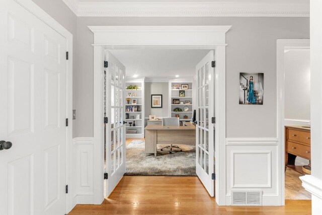 12 Mcintosh Ln, Bedford, NH 03110 - foyer entrance with french doors, wood finished floors, a wainscoted wall, and crown molding