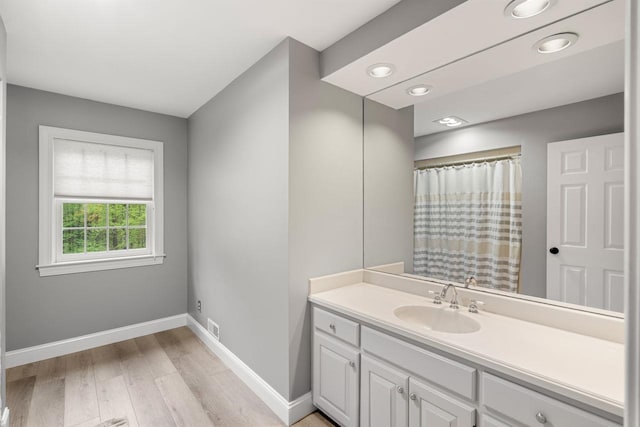 12 Mcintosh Ln, Bedford, NH 03110 - bathroom featuring baseboards, wood finished floors, vanity, recessed lighting, and a shower with shower curtain