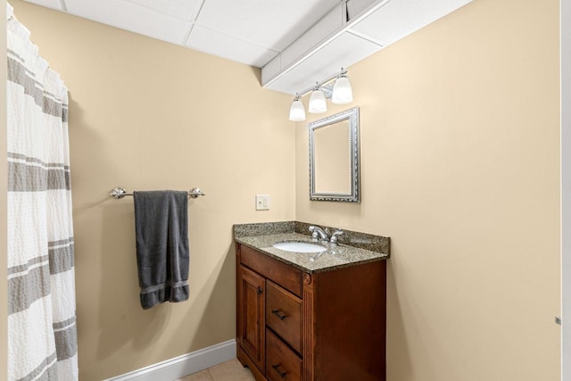 12 Mcintosh Ln, Bedford, NH 03110 - full bathroom with baseboards, vanity, tile patterned floors, a paneled ceiling, and a shower with shower curtain