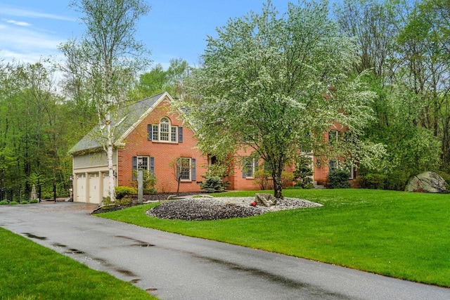 12 Mcintosh Ln, Bedford, NH 03110 - traditional home with a garage, asphalt driveway, a front yard, and brick siding