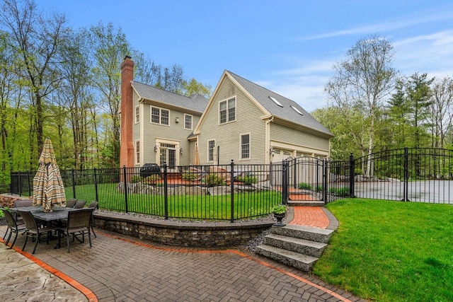 12 Mcintosh Ln, Bedford, NH 03110 - back of property with a chimney, a garage, and a gate