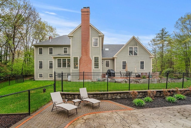12 Mcintosh Ln, Bedford, NH 03110 - rear view of property with a patio and a chimney