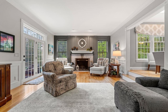 12 Mcintosh Ln, Bedford, NH 03110 - living room featuring ornamental molding, wood finished floors, a decorative wall, and a fireplace