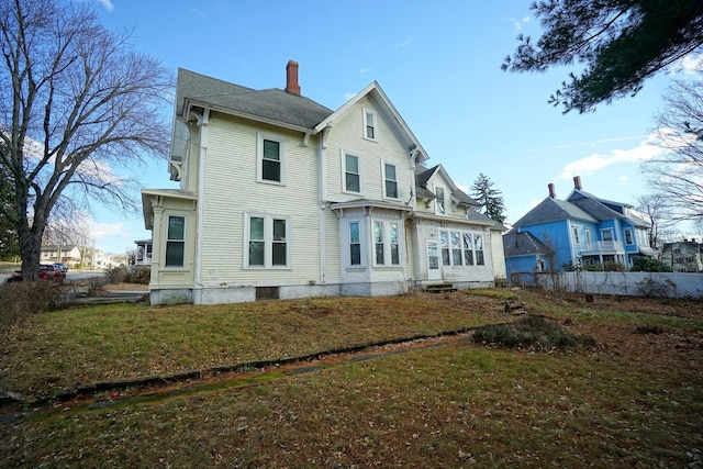 489 Hanover St, Manchester, NH 03104 - rear view of property with a chimney