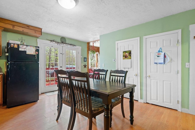 28 Putnam Hill Rd, Lyndeborough, NH 03082 - dining room featuring french doors, a textured ceiling, and light wood-style floors