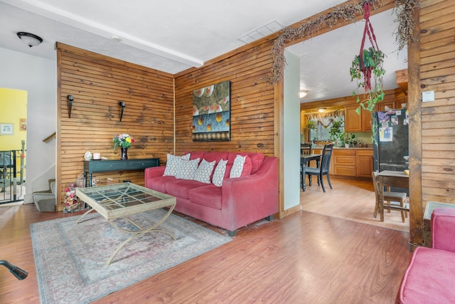 28 Putnam Hill Rd, Lyndeborough, NH 03082 - living room featuring wooden walls, stairway, and light wood finished floors