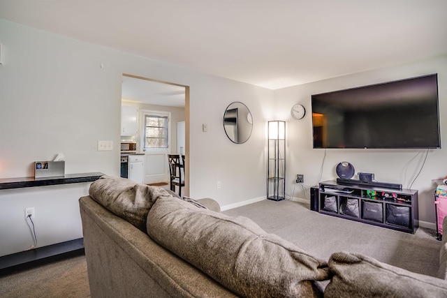 carpeted living room with baseboards