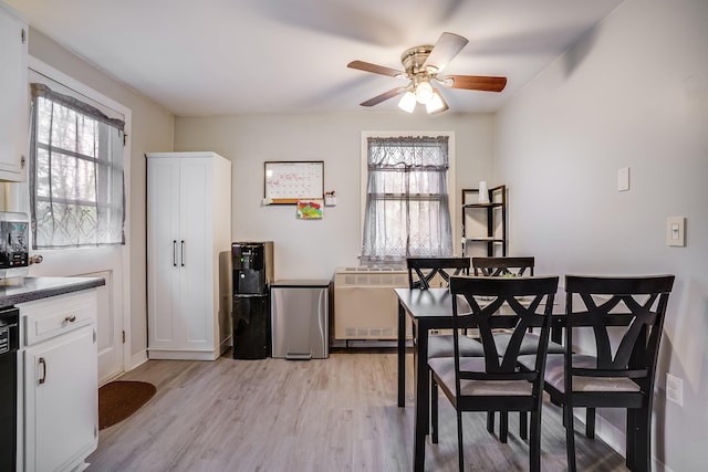 dining area with light wood-style flooring and ceiling fan