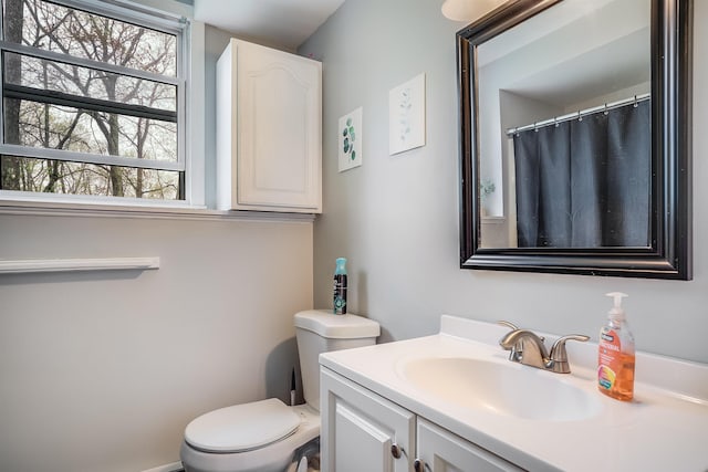 full bath featuring vanity and toilet