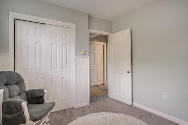 sitting room with carpet flooring and wainscoting