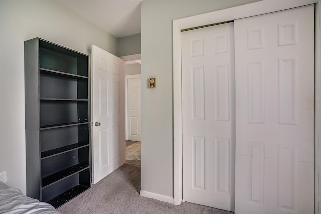 unfurnished bedroom with carpet floors and a closet