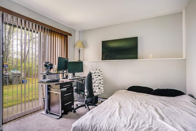 bedroom with carpet flooring and an office area