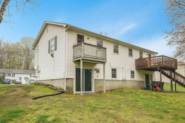 rear view of house featuring a lawn, stairway, a wooden deck, and a balcony