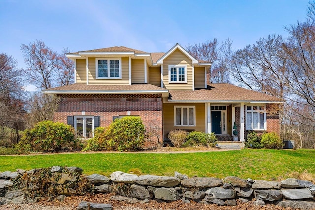 38 Farmington Rd, Nashua, NH 03060 - traditional-style house with brick siding, a front yard, and roof with shingles