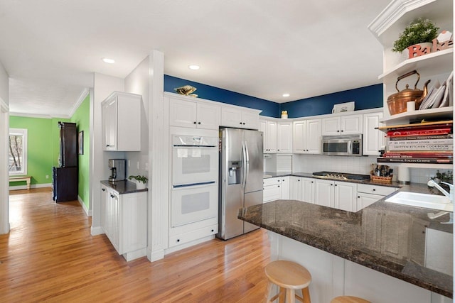 38 Farmington Rd, Nashua, NH 03060 - kitchen featuring appliances with stainless steel finishes, a sink, light wood-style floors, white cabinets, and ornamental molding