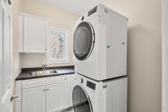 38 Farmington Rd, Nashua, NH 03060 - laundry room featuring stacked washing machine and dryer and cabinet space