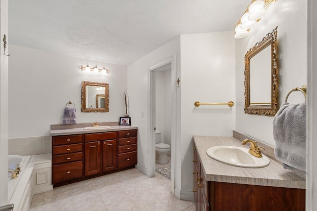 38 Farmington Rd, Nashua, NH 03060 - bathroom featuring two vanities, tile patterned floors, a bath, a textured ceiling, and toilet