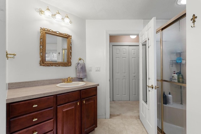 38 Farmington Rd, Nashua, NH 03060 - bathroom featuring vanity, tile patterned floors, a closet, and a shower with shower door