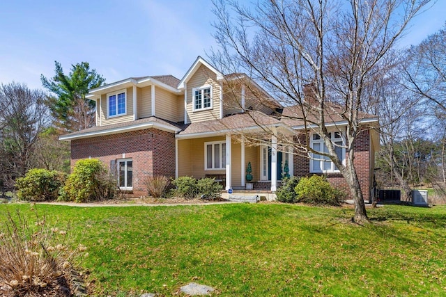 38 Farmington Rd, Nashua, NH 03060 - view of front of home featuring brick siding, covered porch, a front lawn, and a chimney