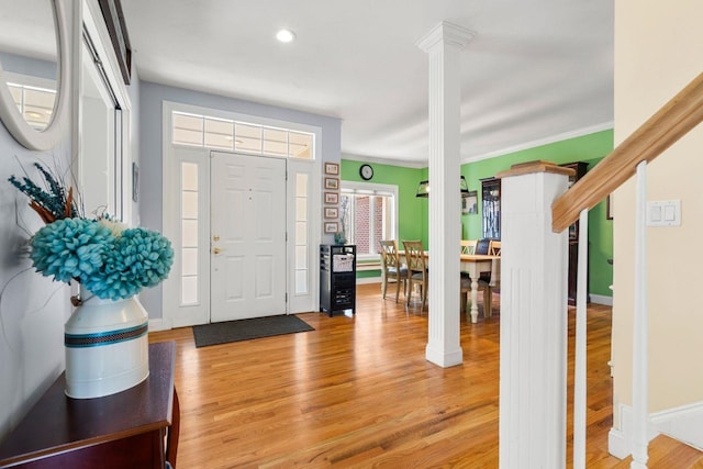 38 Farmington Rd, Nashua, NH 03060 - foyer entrance with ornate columns, light wood-type flooring, recessed lighting, baseboards, and ornamental molding
