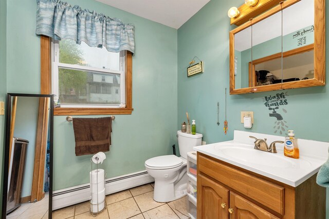 bathroom with baseboard heating, toilet, tile patterned floors, and vanity